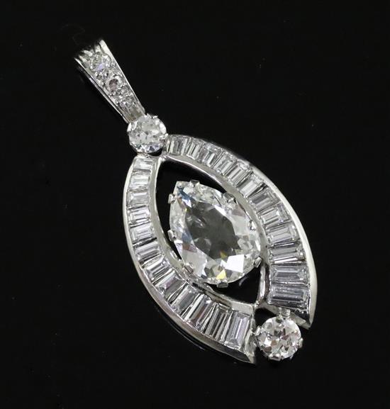 A platinum or white gold, pear, baguette and round cut diamond set elliptical shaped pendant,